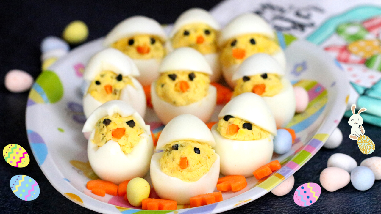 Easter Chick Deviled Eggs with carrot beaks and olive eyes on a serving platter