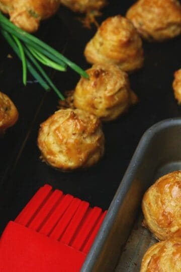 golden gougères French cheese puffs fresh from the oven on a cooling rack