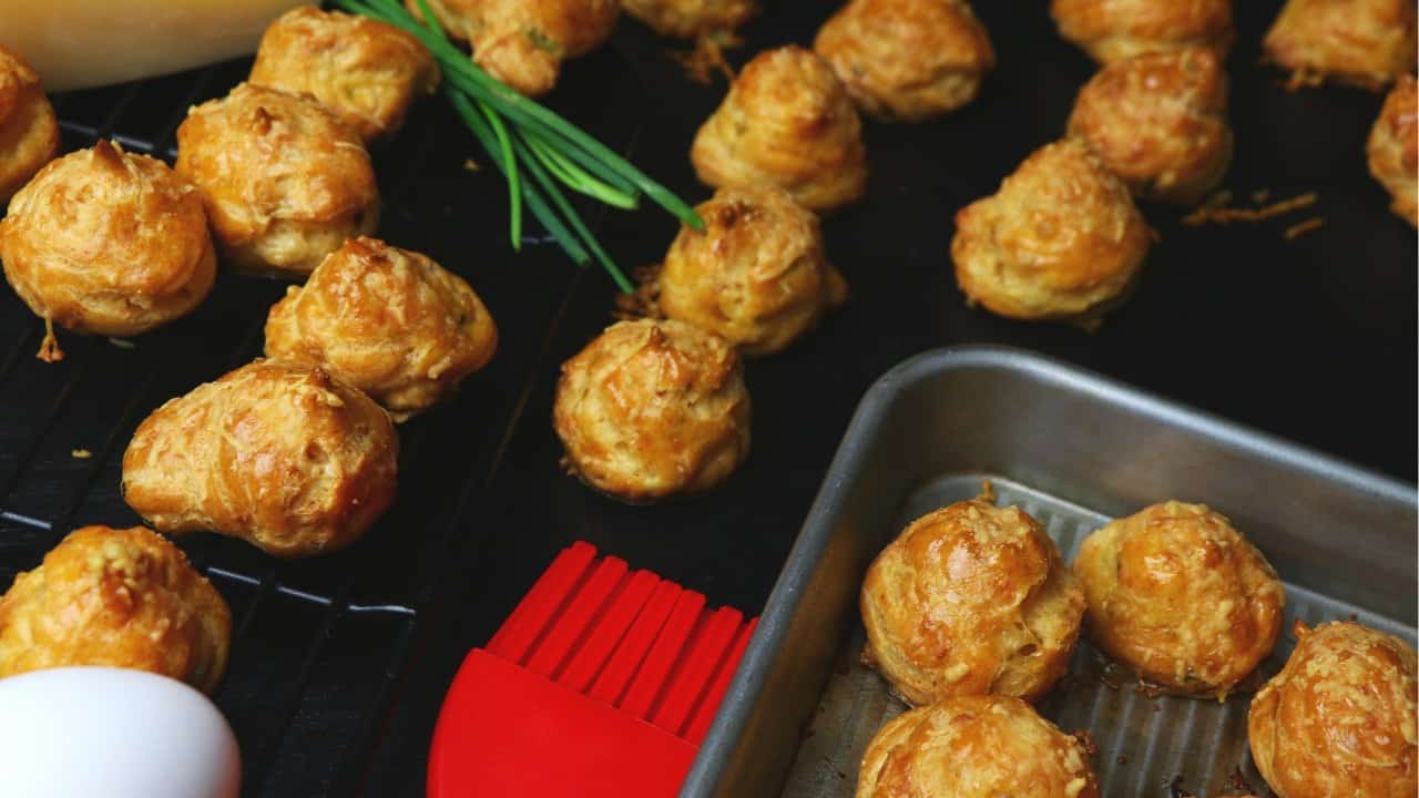 golden gougères French cheese puffs fresh from the oven on a cooling rack