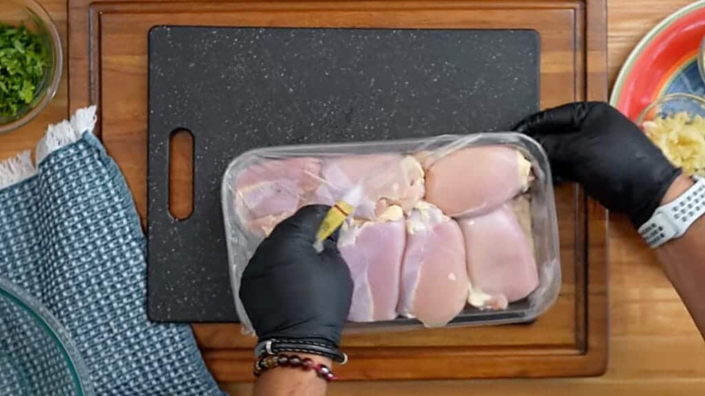 Seasoning the chicken with spices for slow cooker butter chicken