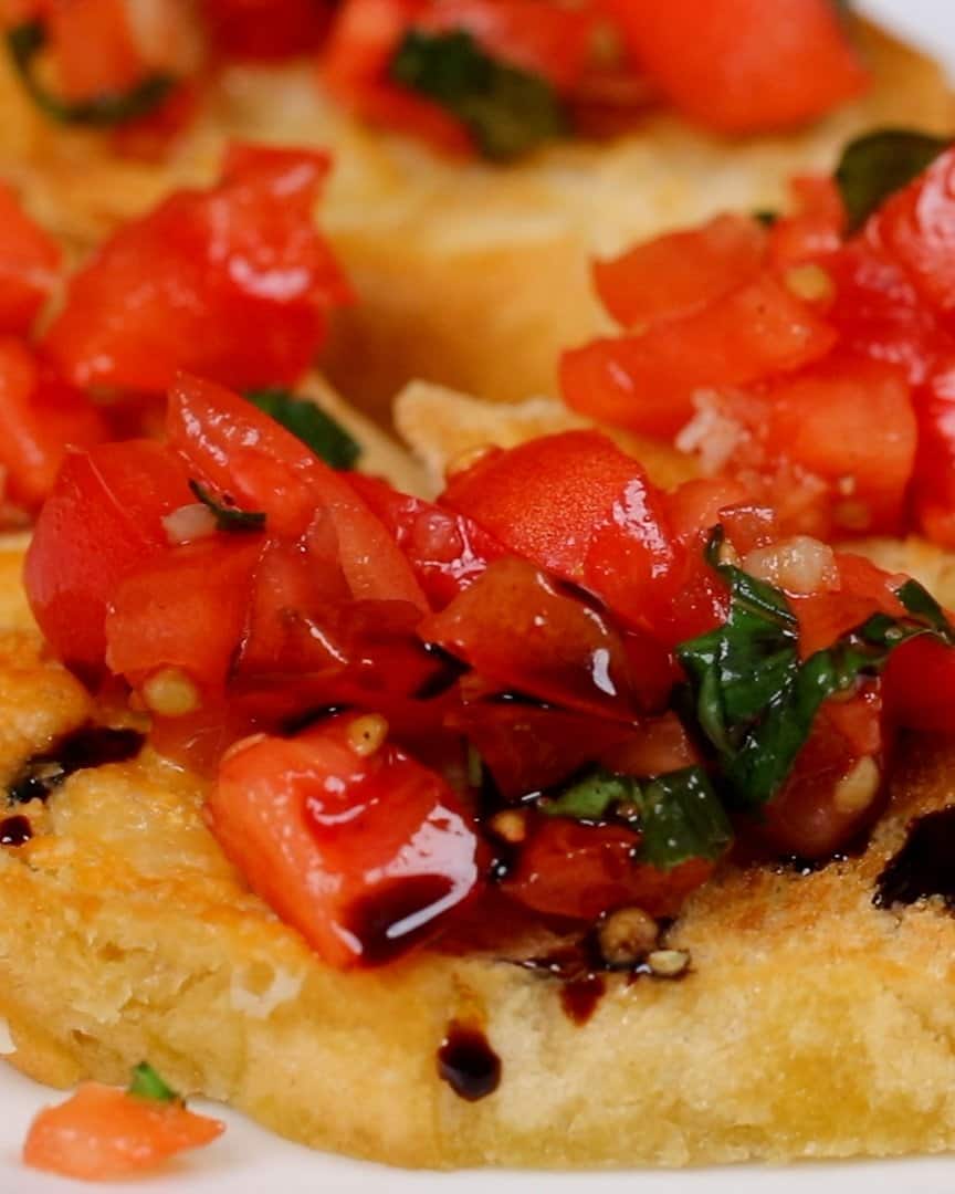 Close up of Italian bruschetta topped with tomato basil mixture