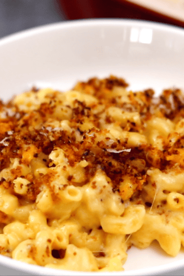 Bowl of creamy baked mac and cheese with crispy breadcrumb topping