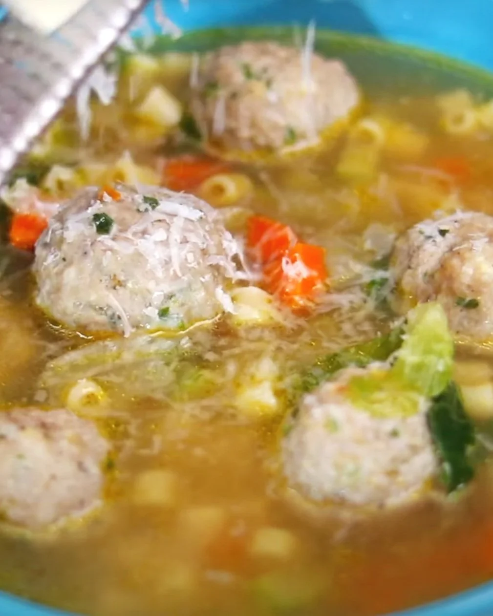 Meatball soup in a blue bowl