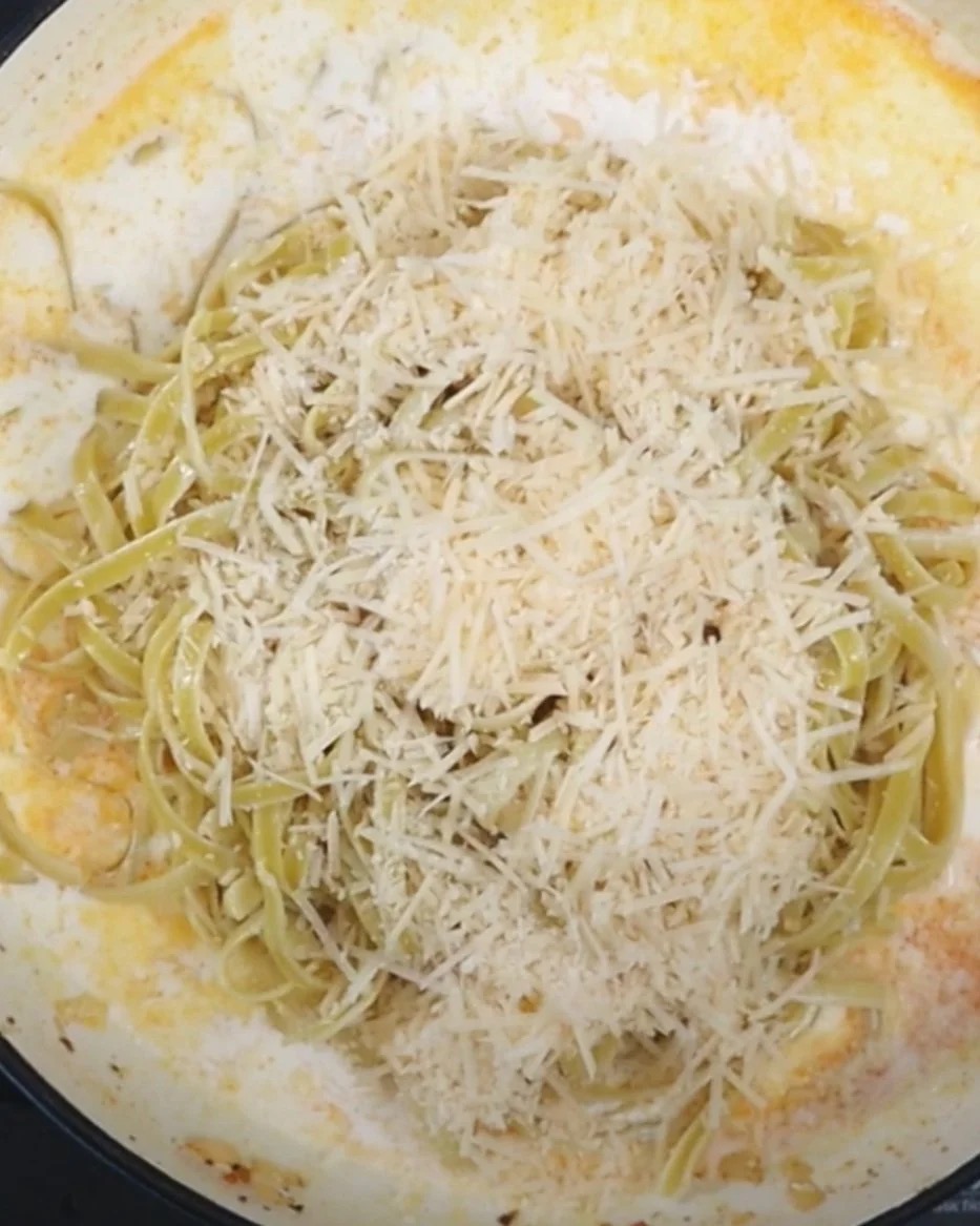 Pasta with shredded cheese in cream sauce