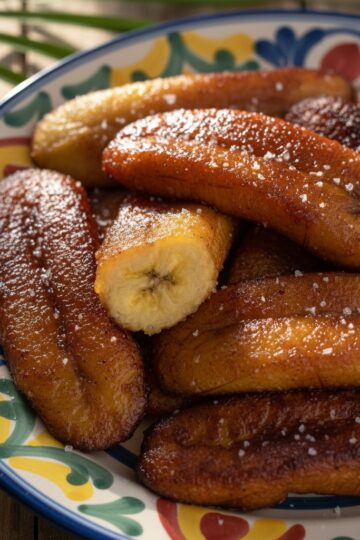 Dominican plátanos maduros - golden caramelized fried sweet plantains on a plate