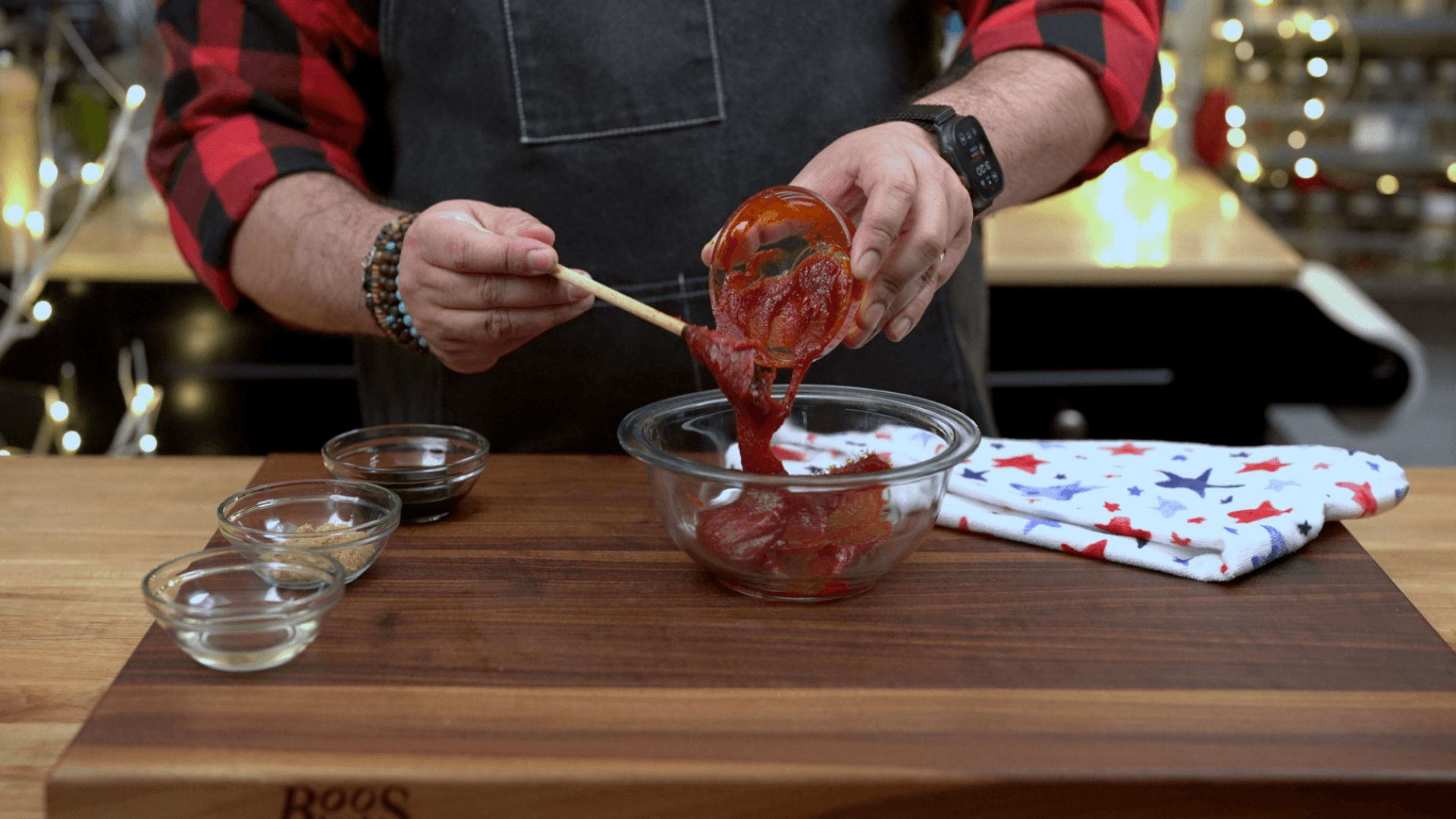 Scooping gochujang paste into a glass bowl to make the Korean pork bowl sauce