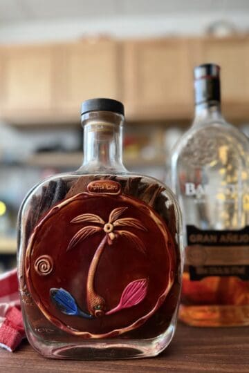 Mamajuana bottle with Dominican bark and herbs, Barceló rum in background
