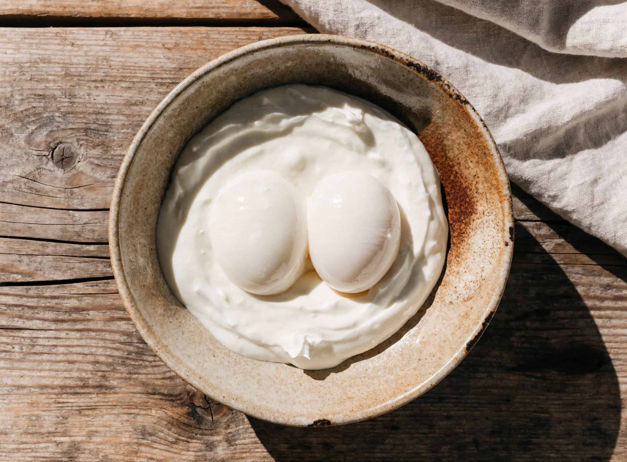 Poached eggs nestled on garlicky yogurt